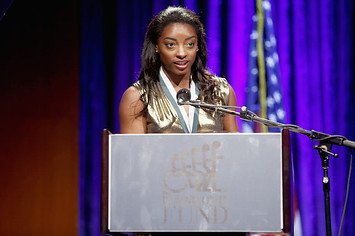 Simone Biles speaks onstage during the 32nd Annual Great Sports Legends Dinner.