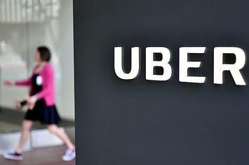 A woman walks into the Uber Corporate Headquarters building in San Francisco, California.