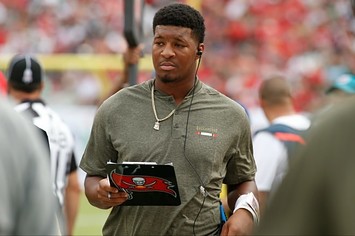 Jameis Winston stands on the sideline.