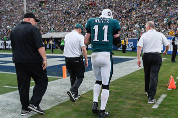 Carson Wentz walks off the field with a suspected torn ACL.