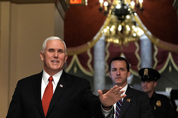 Mike Pence waves as he walks towards the House chamber