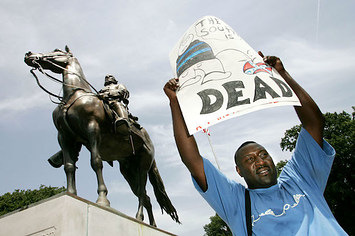 Protester Maurice Spivey holds up a sign to protest