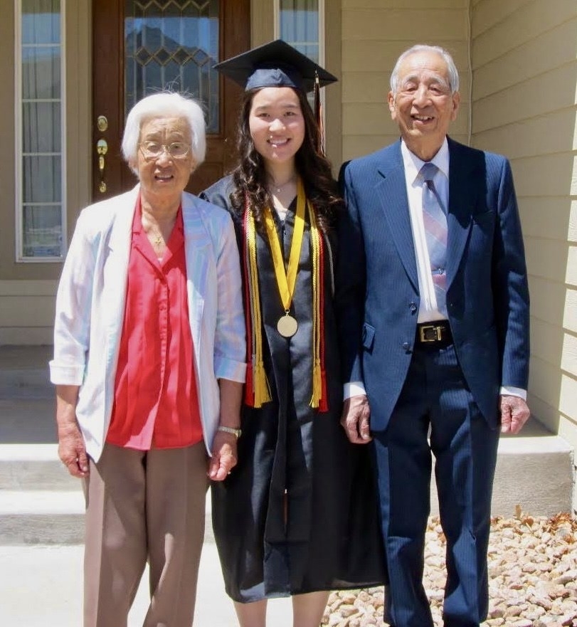 Michelle at her college graduation with her grandparents