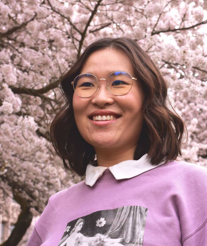 headshot of Michelle in front of cherry blossom trees
