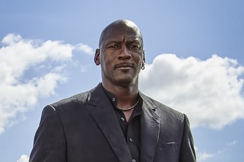 Michael Jordan in a suit in front of a blue sky