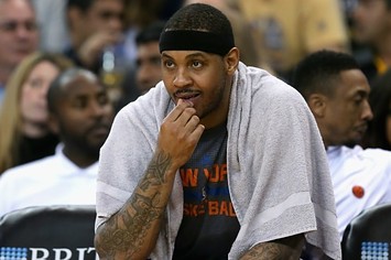 Carmelo Anthony sits on the bench for the Knicks.