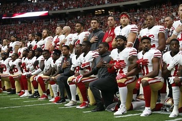 49ers players kneel during the national anthem.