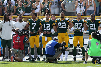 Aaron Rodgers links arms during anthem