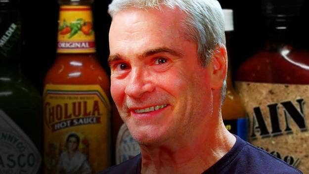 Henry Rollins takes on the Hot Ones challenge with host Sean Evans. 