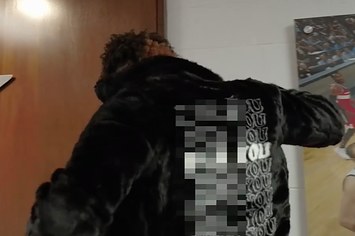 Kelly Oubre Jr. shows off his NSFW Supreme coat.