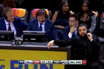 Drake speaks with Raptors announcers during their win over the 76ers.