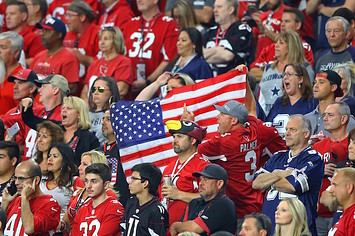 Arizona Cardinals fans hold an american flag.