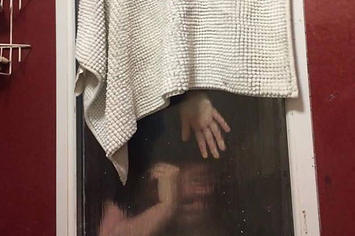 A woman gets stuck in a bathroom window after attempting to throw her poop out of it.