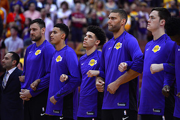 Los Angeles Lakers lock arms during the national anthem