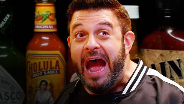 Adam Richman takes on the Hot Ones challenge with host Sean Evans. 