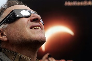 A man watches a solar eclipse.