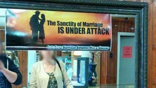 A jewelry store sign in Newfoundland prompts a same-sex couple to ask for refund. 