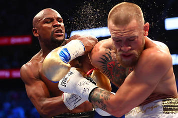 Mayweather lands a shot against Conor McGregor during their bout.