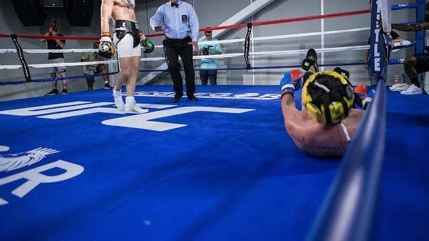 Conor McGregor's sparring partner Paulie Malignaggi quit on Thursday after photos surfaced that appeared to show McGregor knocking him down in the ring.