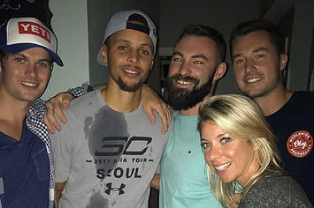 Stephen Curry poses with some people after crashing a house party.