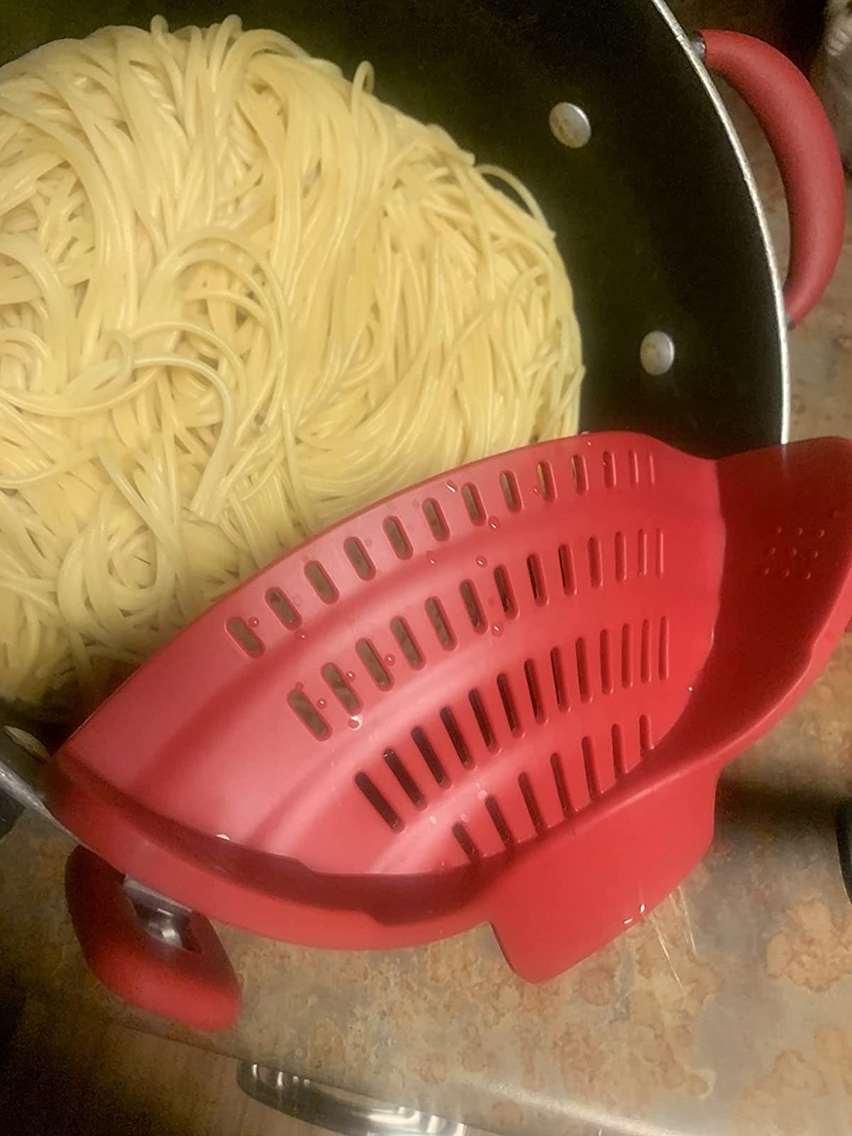 Reviewer image of red strainer on pot with spaghetti