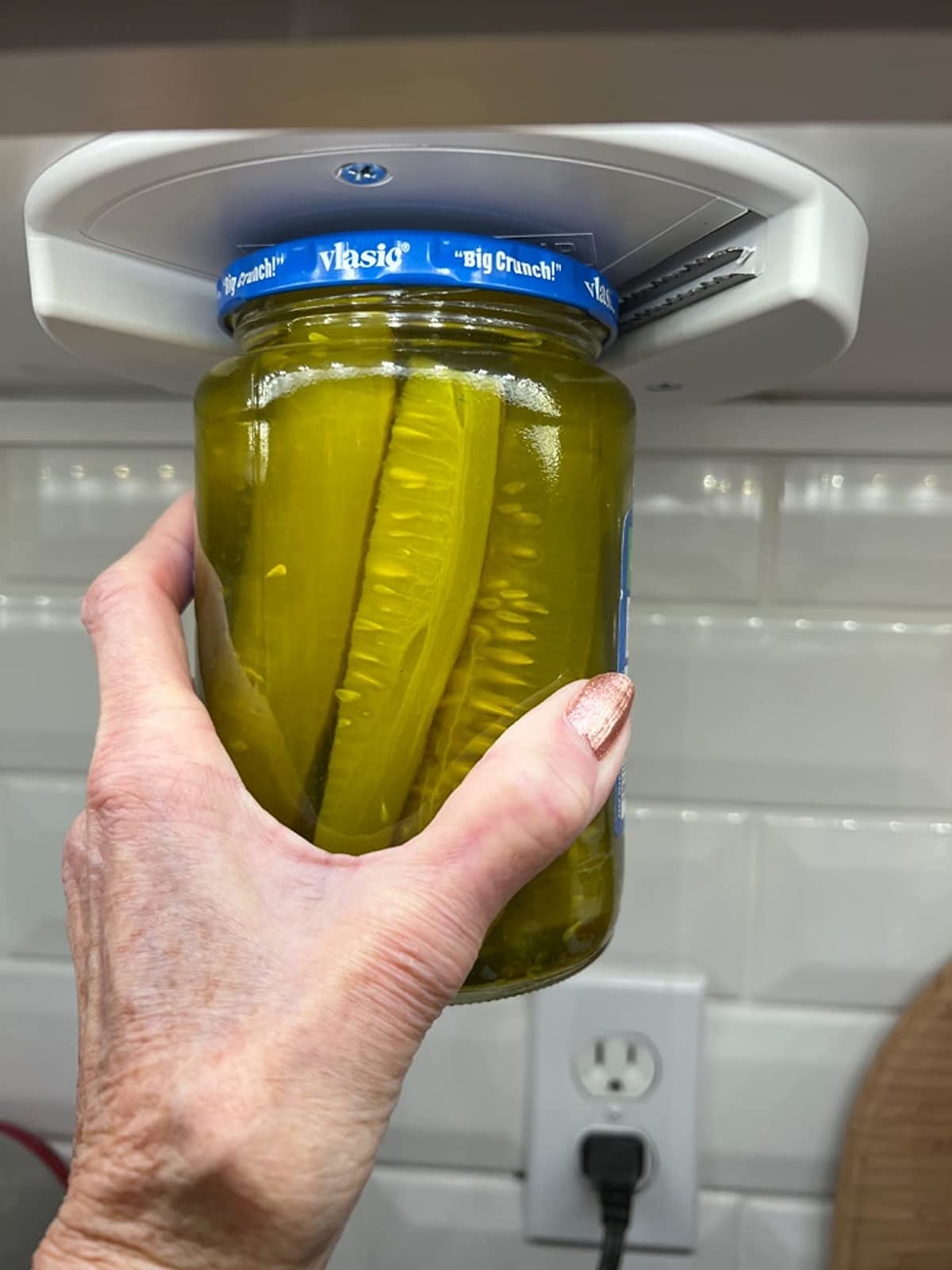 Reviewer opening jar of pickles