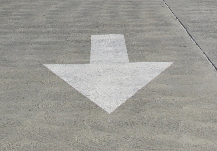 a white arrow painted on the ground