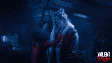 santa and trudy hugging in violent night
