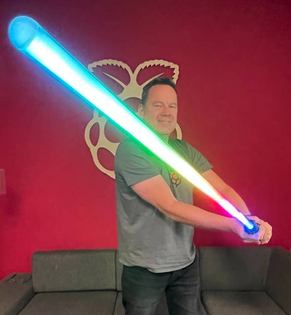 Toby Roberts holding a lightsaber
