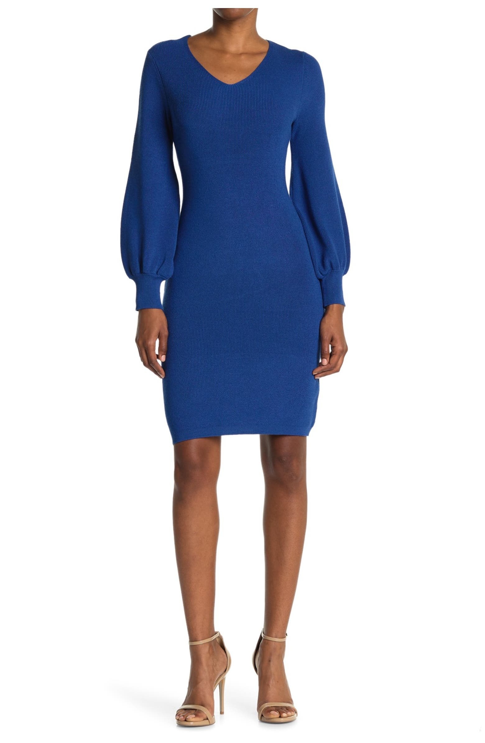 model in blue knee-length knit dress with a v-neck and long balloon sleeves