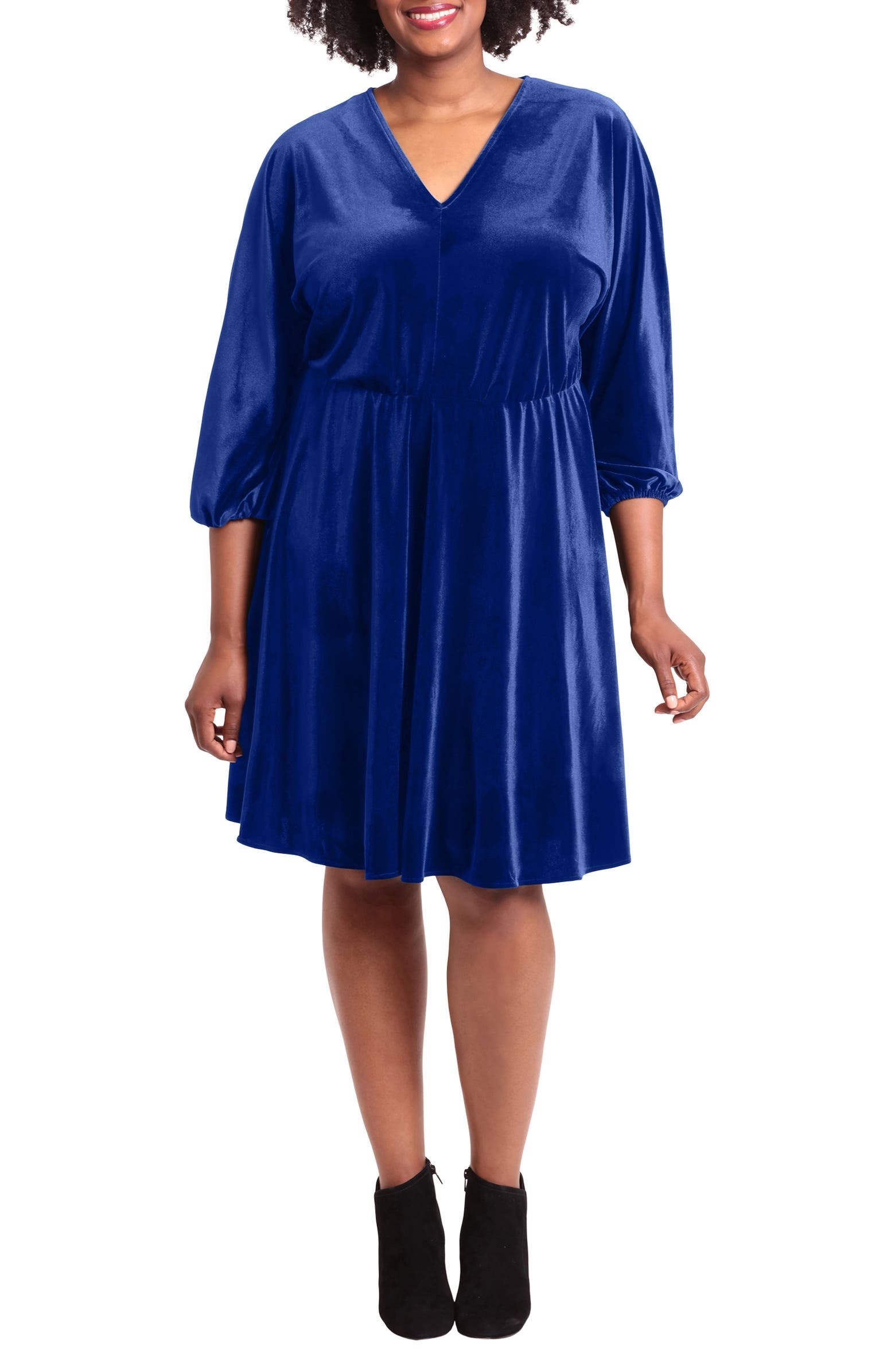 model in blue velvet knee-length dress with a v-neck and three quarter poofed sleeves