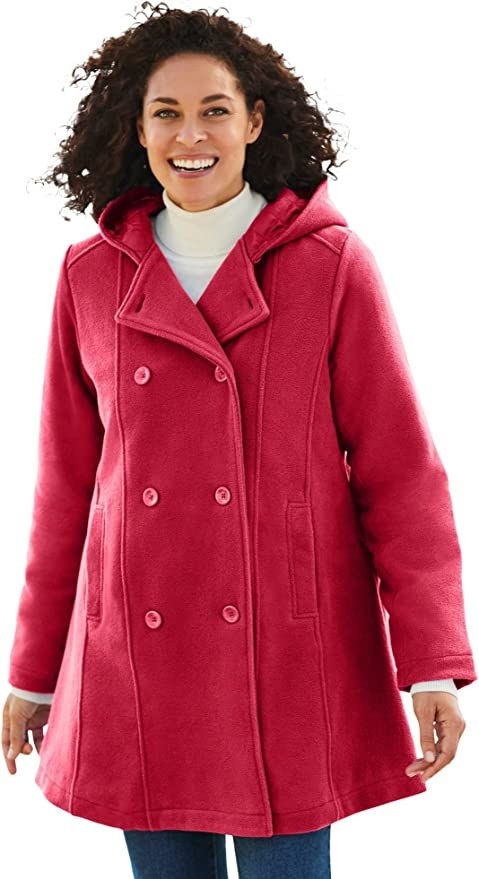 A model wearing a red coat with blue bottoms