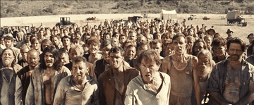 Movei gif: A film set with lots of grimy men yelling