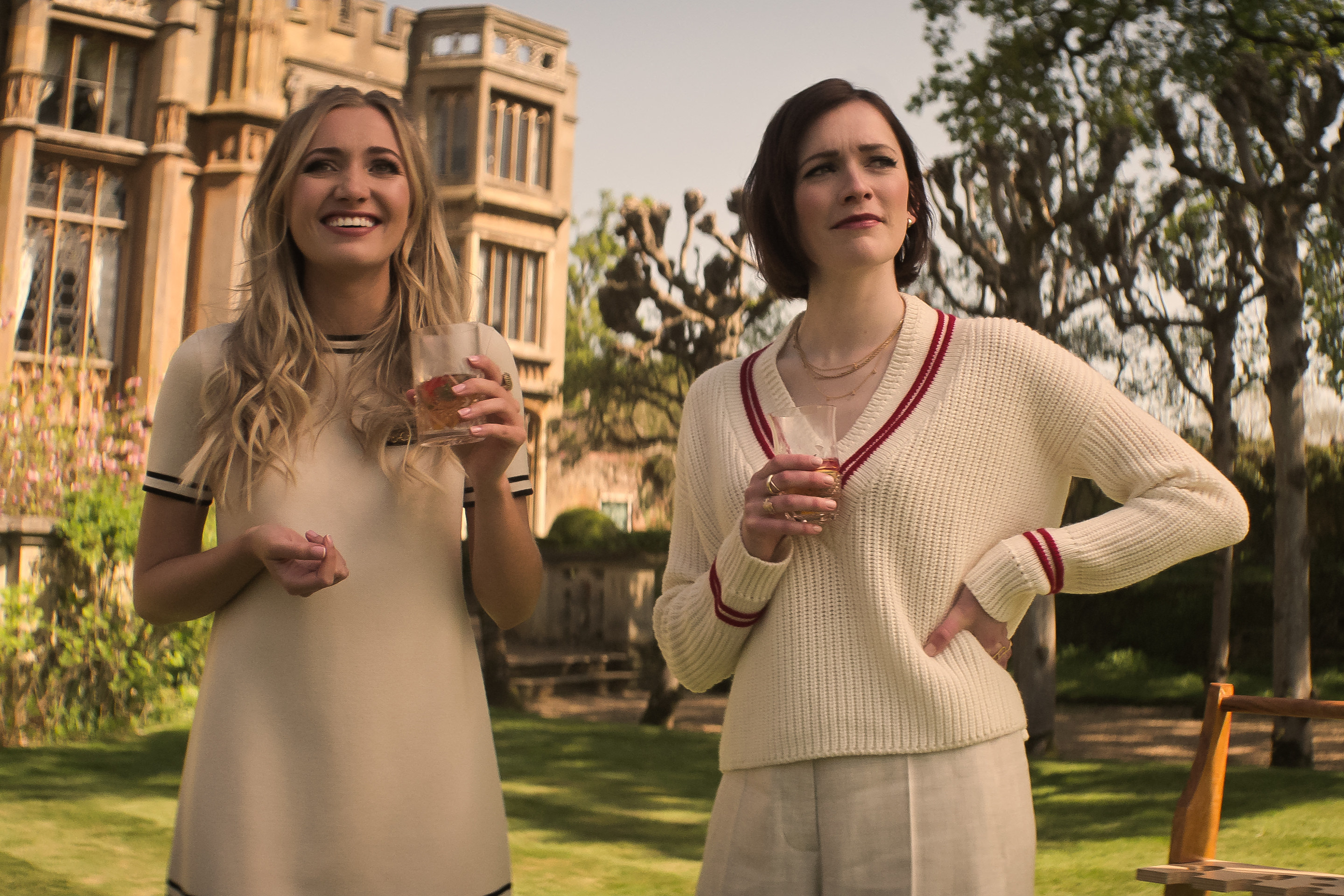 Kate and Phoebe standing outside holding cocktails