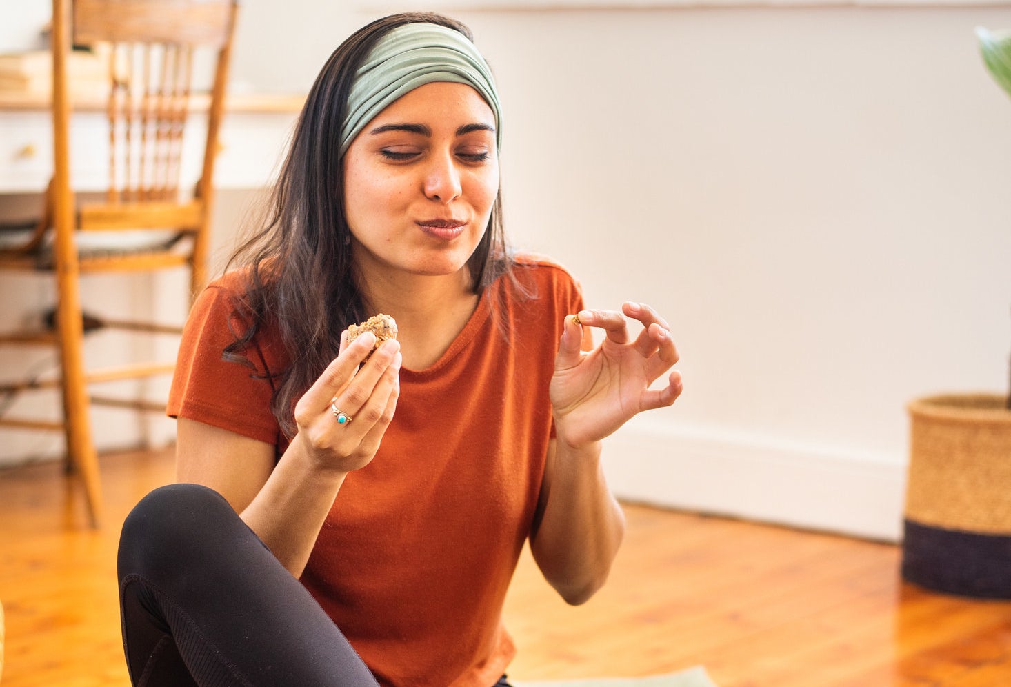 A woman enjoys a protein ball after a workout