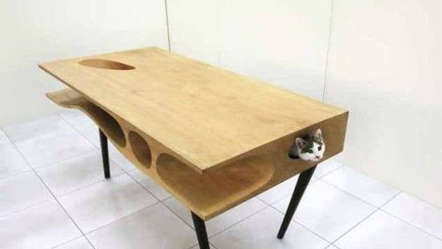 Hong-Kong based architecture firm Lycs has designed a dining room table with passageways, tunnels, and holes that will keep your feline friends occupied.