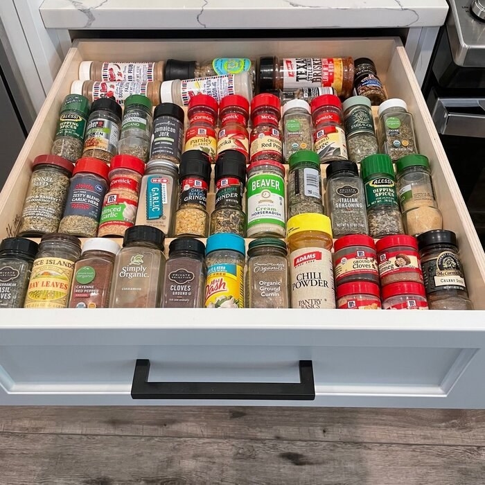 The rack in a drawer with spices on it