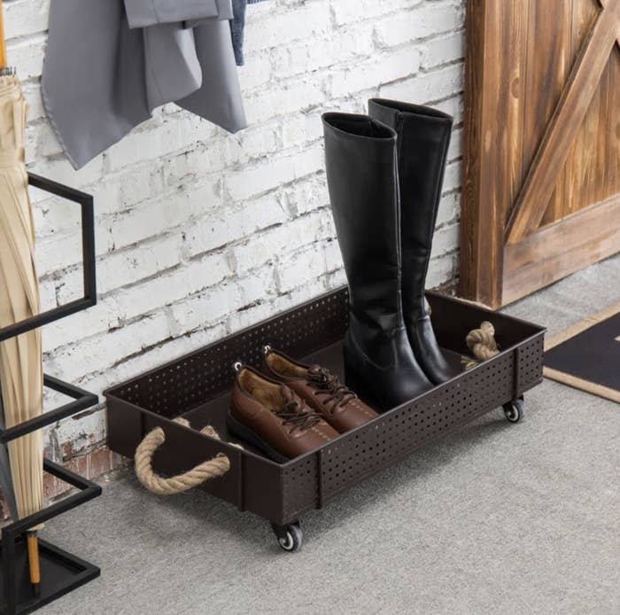 metal storage bin with a pair of boot and a pair of loafers inside