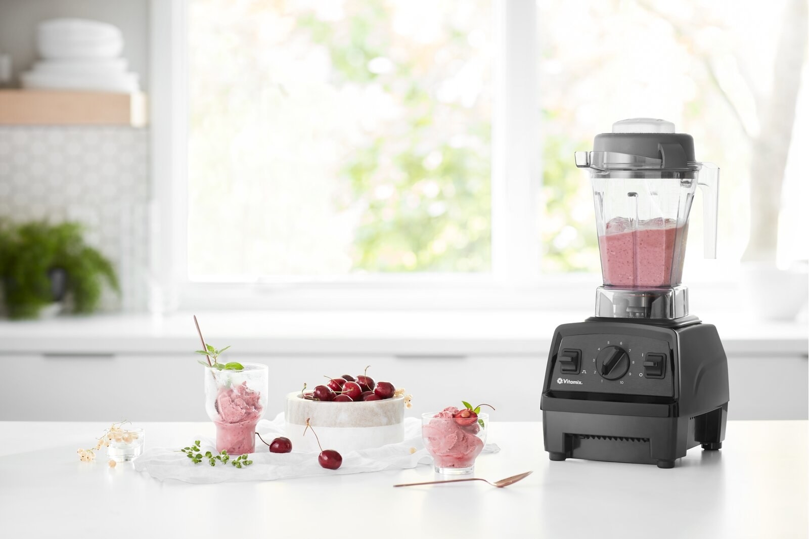 The blender on a counter with smoothie in it