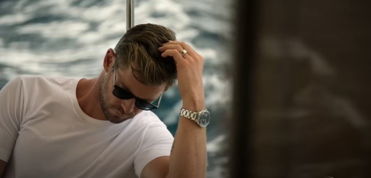 Chris on a boat, looking pensive
