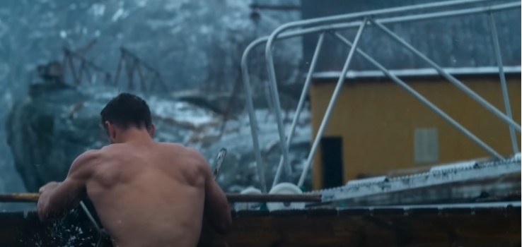 Chris Hemsworth lowering himself into the icy waters of Norway