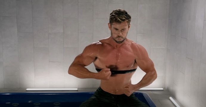 Chris Hemsworth breathing out intensely, his skin red and sweaty from the heat
