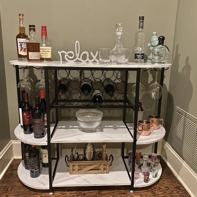 The wine rack on display with various wines and cocktail tools
