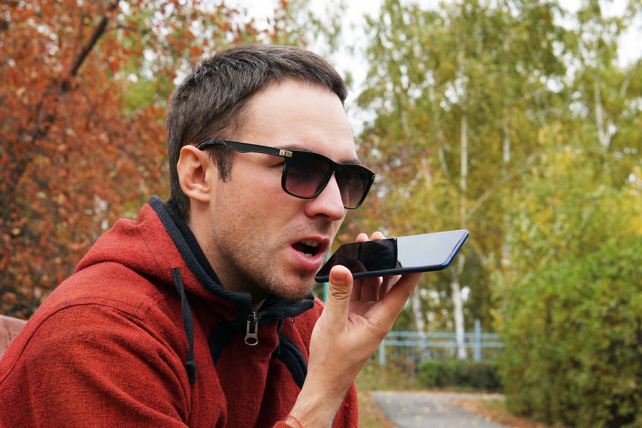 a man talking on his cellphone using the speakerphone option