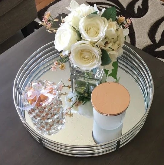 The tray in silver with a candle and plant on it