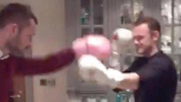 Wayne Rooney boxes former teammate Phil Bardsley in his kitchen.