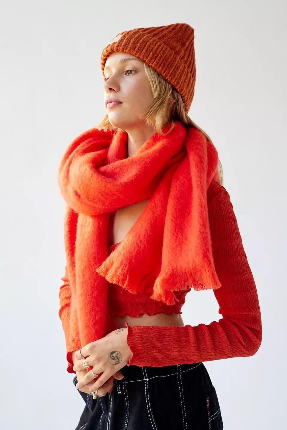 a model wearing the scarf in bright orange