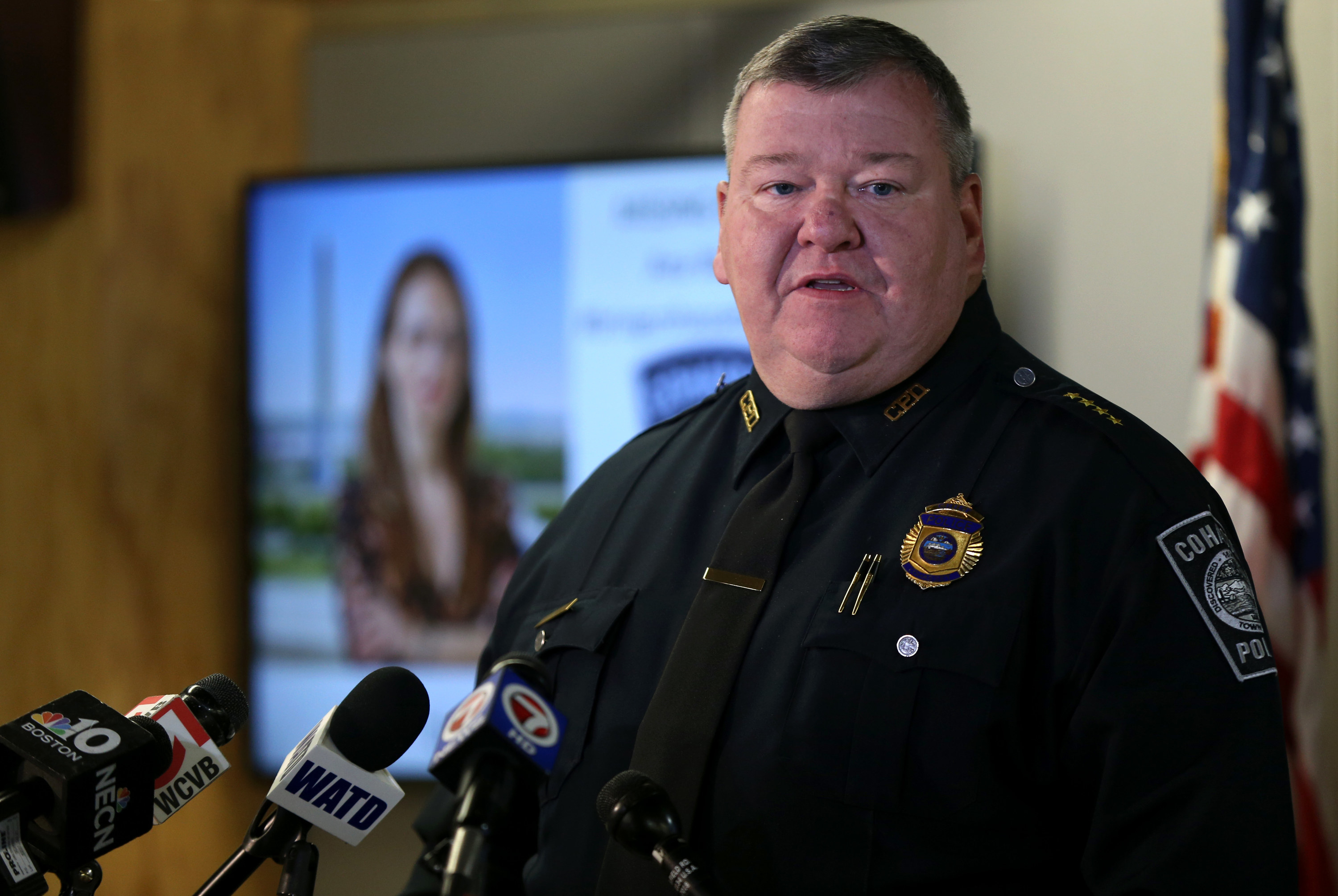 Police press conference about Ana Walshe, whose photo can be seen in the background