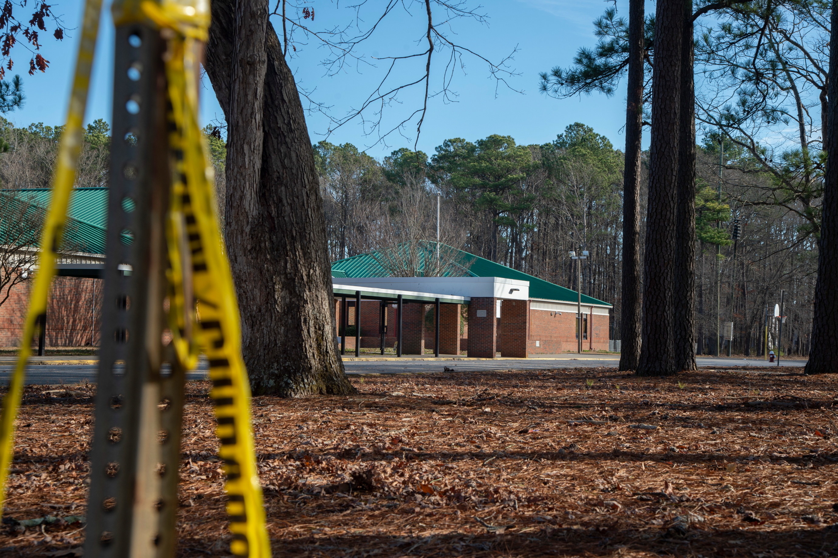 Police tape hangs from a sign post outside Richneck Elementary School following a shooting on January 7, 2023, in Newport News, Virginia