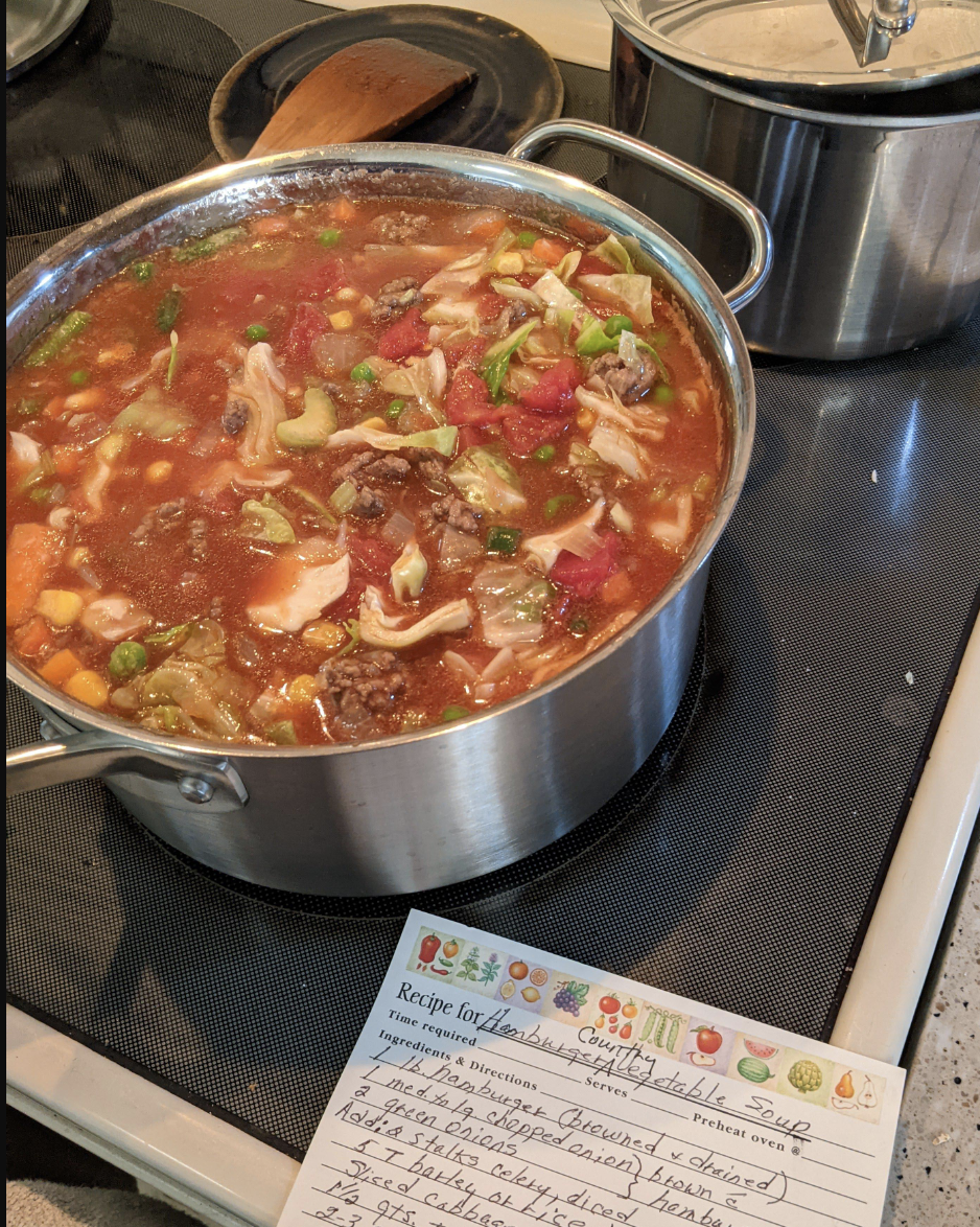 Girl Scout stew with a handwritten recipe for Hamburger Country Vegetable Soup
